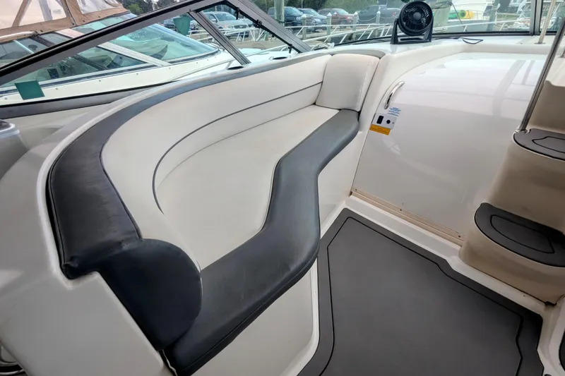 Slide: The Image of 2000 Cruisers Yachts 3870 Express interior with curved seating and modern design. - 10