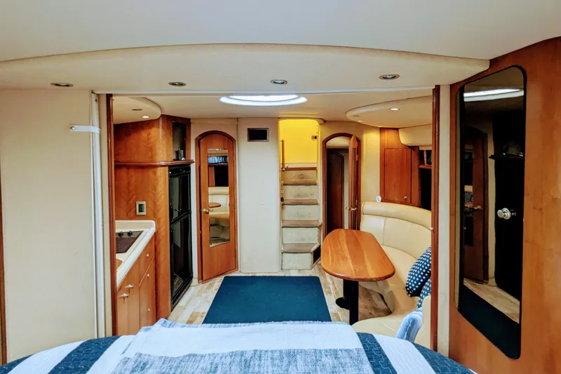 Slide: The Image of Interior of 2000 Cruisers Yachts 3870 Express, featuring kitchen, dining area, and stairs. - 17