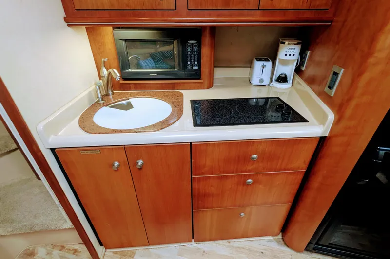 Slide: The Image of 2000 Cruisers Yachts 3870 Express kitchen with sink, stove, and appliances. - 20