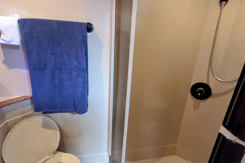 Slide: The Image of Bathroom interior of 2000 Cruisers Yachts 3870 Express with shower and towel. - 27