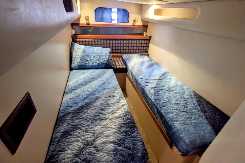 Slide: The Image of 2000 Cruisers Yachts 3870 Express cabin with twin beds and blue bedding. - 29