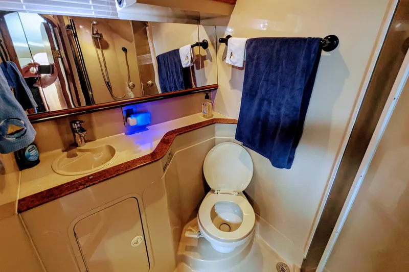 Slide: The Image of Bathroom interior of 2000 Cruisers Yachts 3870 Express with sink, toilet, and towels. - 31