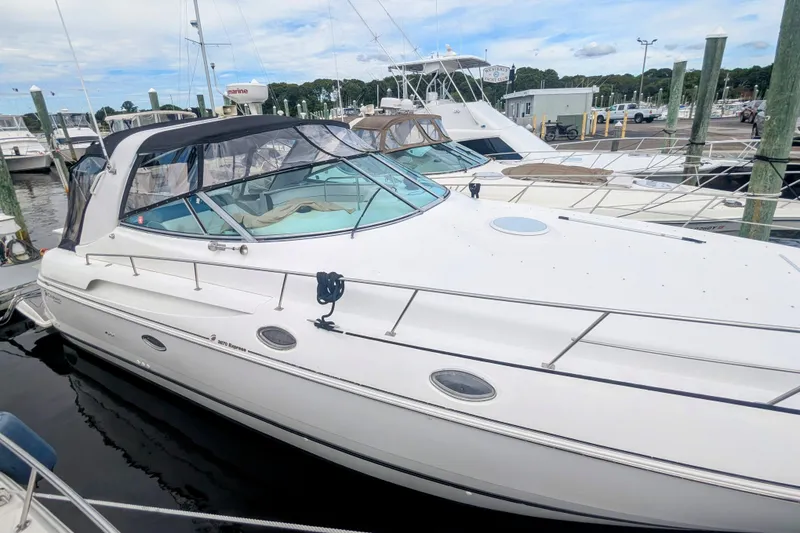 Slide: The Image of 2000 Cruisers Yachts 3870 Express docked at marina, featuring sleek white design. - 4
