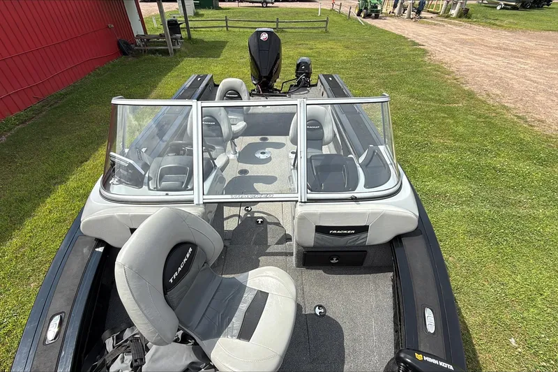 Slide: The Image of 2019 Tracker Targa V-19 WT Tournament Edition boat with seating and windshield, parked on grass. - 4