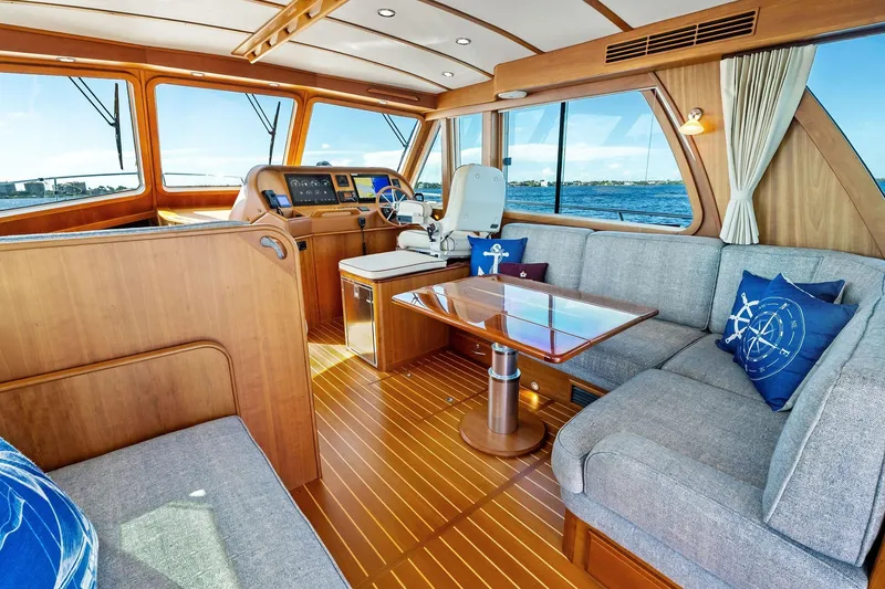 Slide: The Image of Luxurious 2019 Sabre Flybridge yacht interior with elegant wood finish and comfortable seating. - 14