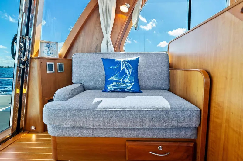 Slide: The Image of Luxurious 2019 Sabre Flybridge interior with cozy seating and nautical decor. - 16