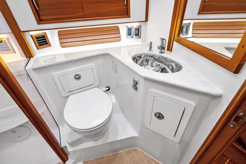 Slide: The Image of 2019 Sabre Flybridge yacht bathroom with modern fixtures and wooden accents. - 31