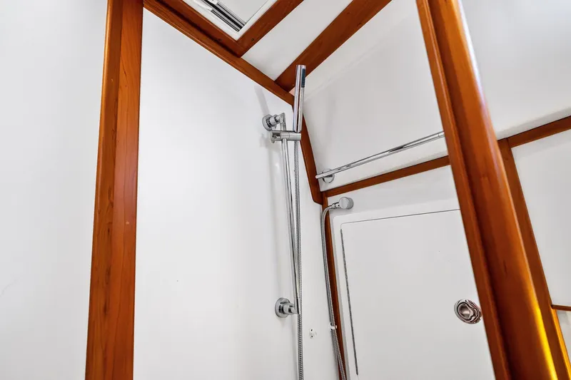 Slide: The Image of Shower area in 2019 Sabre Flybridge yacht with wooden trim and chrome fixtures. - 32