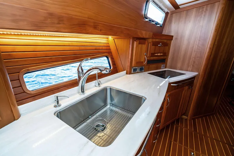 Slide: The Image of Luxurious 2019 Sabre Flybridge yacht kitchen with wooden cabinetry and ocean view. - 37
