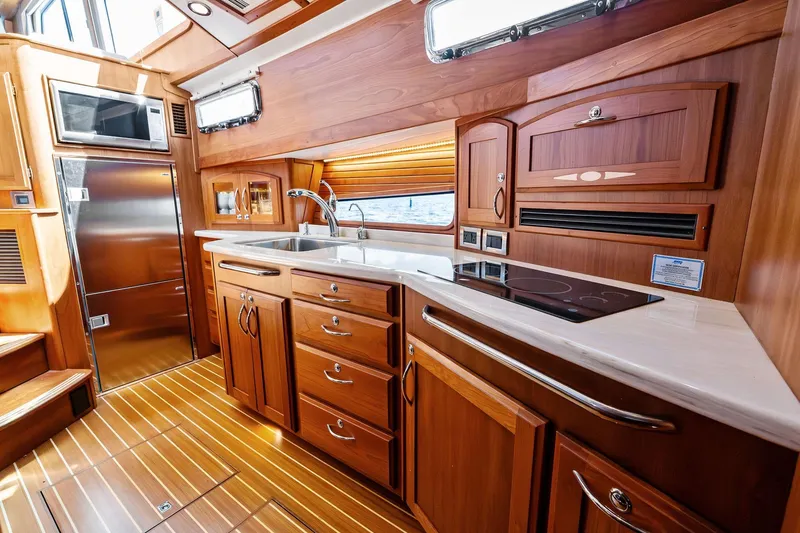 Slide: The Image of Luxurious 2019 Sabre Flybridge yacht kitchen with wood cabinetry and modern appliances. - 4