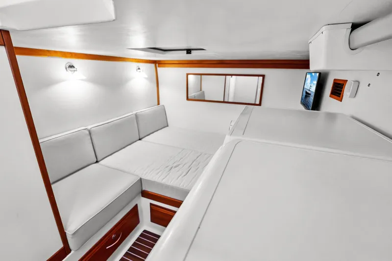 Slide: The Image of 2019 Sabre Flybridge interior with white seating, wooden accents, and wall-mounted TV. - 42