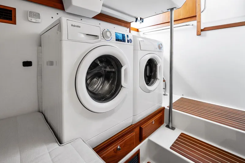 Slide: The Image of Laundry area inside 2019 Sabre Flybridge yacht with washer and dryer. - 44