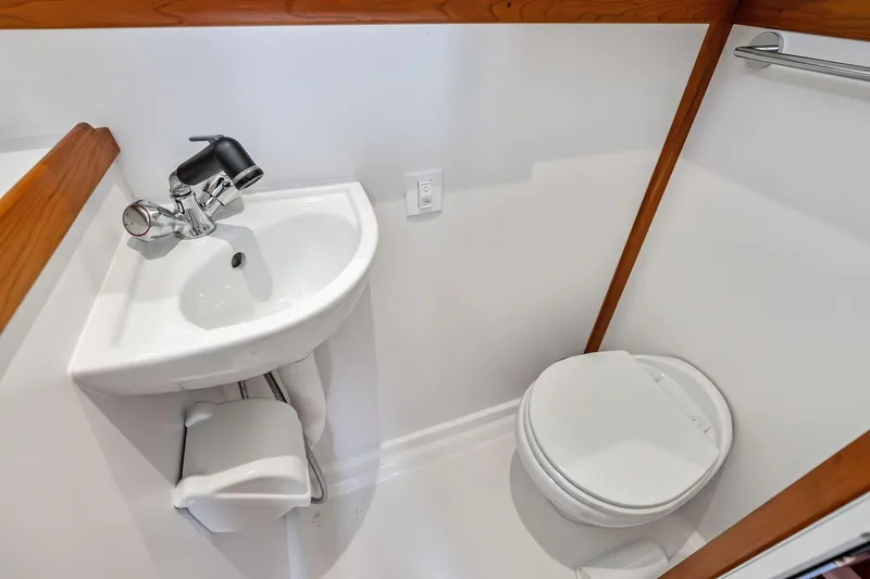 Slide: The Image of Compact bathroom in 2019 Sabre Flybridge yacht with sink and toilet. - 45