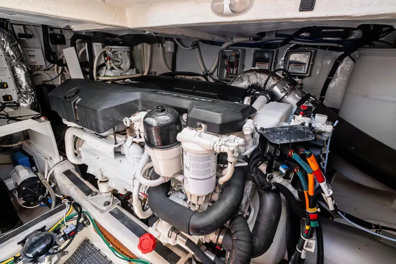 Slide: The Image of Engine room of a 2019 Sabre Flybridge yacht, showcasing complex machinery and wiring. - 46