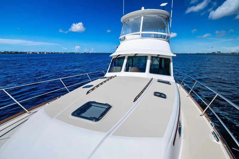 Slide: The Image of 2019 Sabre Flybridge yacht on open water under clear blue sky. - 48