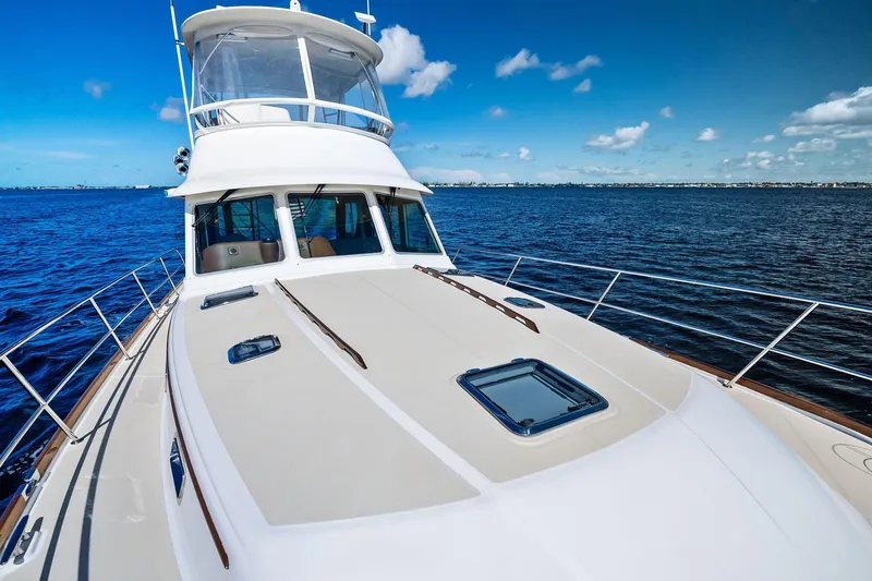 Slide: The Image of 2019 Sabre Flybridge yacht on open water under clear blue sky. - 49