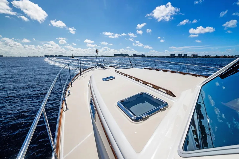 Slide: The Image of 2019 Sabre Flybridge yacht cruising on open water under a clear blue sky. - 50
