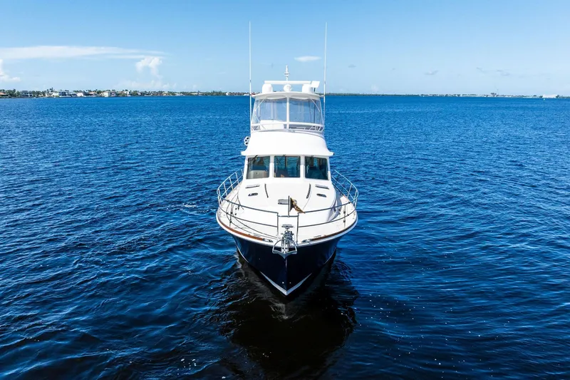 Slide: The Image of 2019 Sabre Flybridge yacht cruising on open blue waters under clear skies. - 54