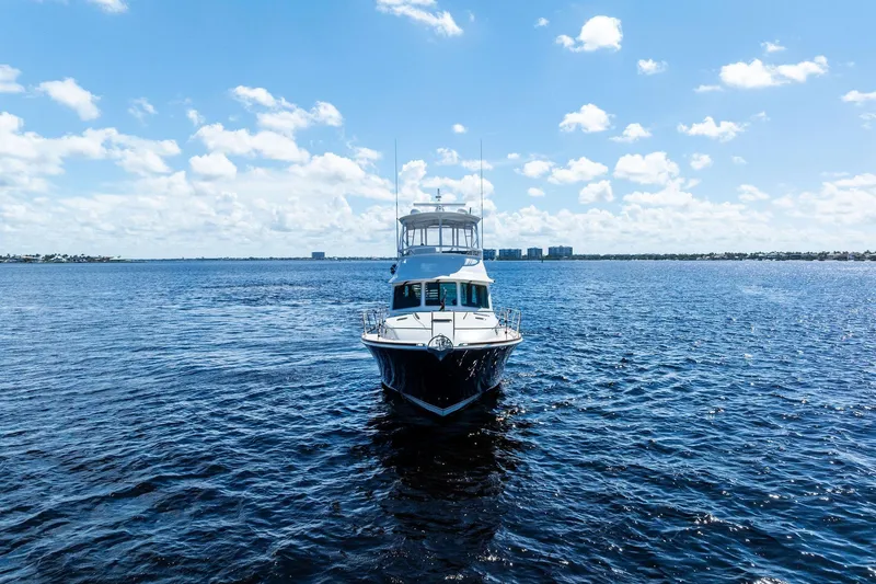 Slide: The Image of 2019 Sabre Flybridge yacht on open water under a clear blue sky. - 55