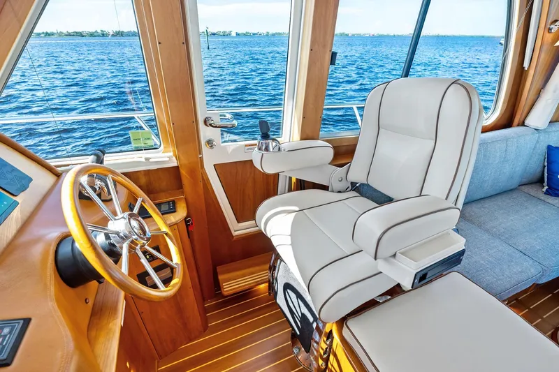 Slide: The Image of Interior of 2019 Sabre Flybridge yacht with steering wheel and plush captain's chair. - 7