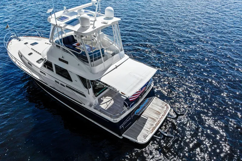 Slide: The Image of 2019 Sabre Flybridge yacht on sparkling blue water, aerial view. - 70