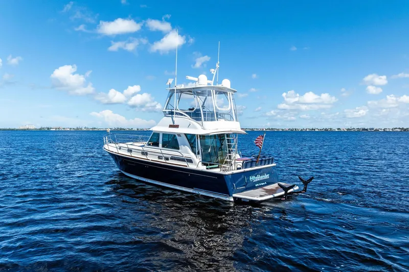 Slide: The Image of 2019 Sabre Flybridge yacht on open water under a clear blue sky. - 71