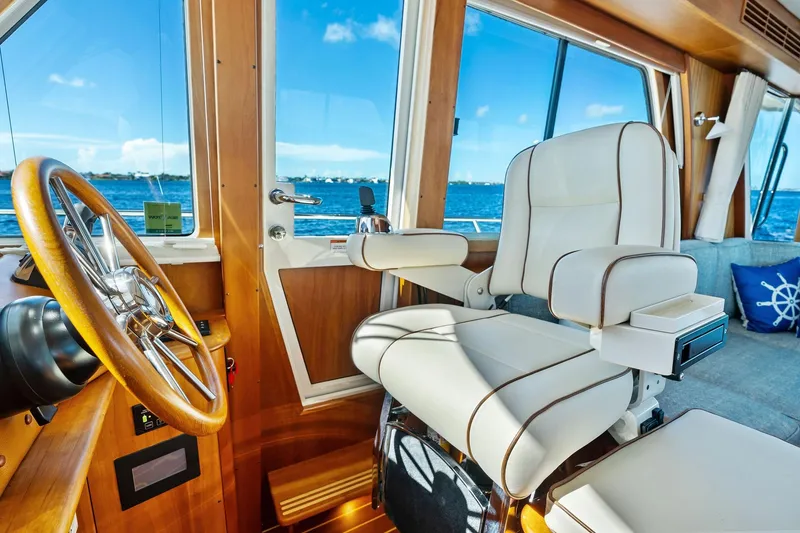 Slide: The Image of Luxurious interior of 2019 Sabre Flybridge yacht with captain's chair and steering wheel. - 8