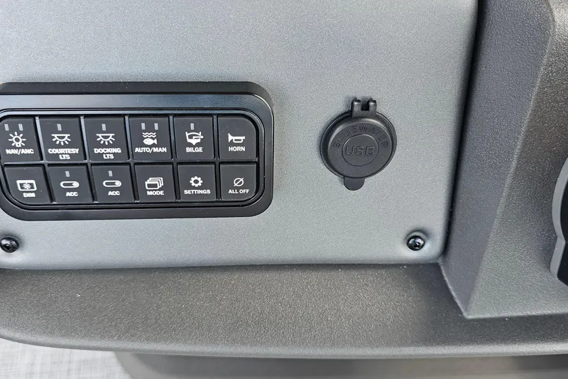 Slide: The Image of Control panel and USB port on 2026 Sun Tracker Sportfish 24 XP3 boat. - 13