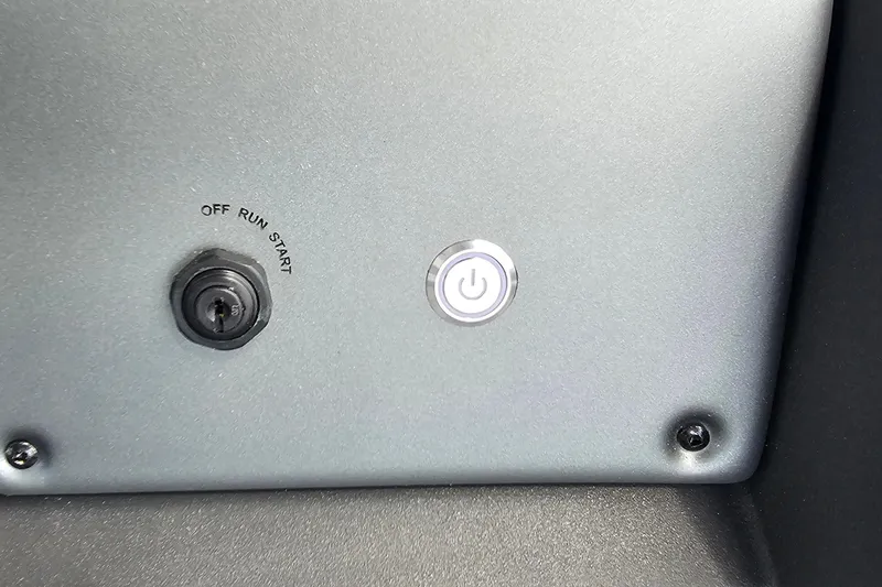 Slide: The Image of Control panel of 2026 Sun Tracker Sportfish 24 XP3 with ignition and power button. - 15