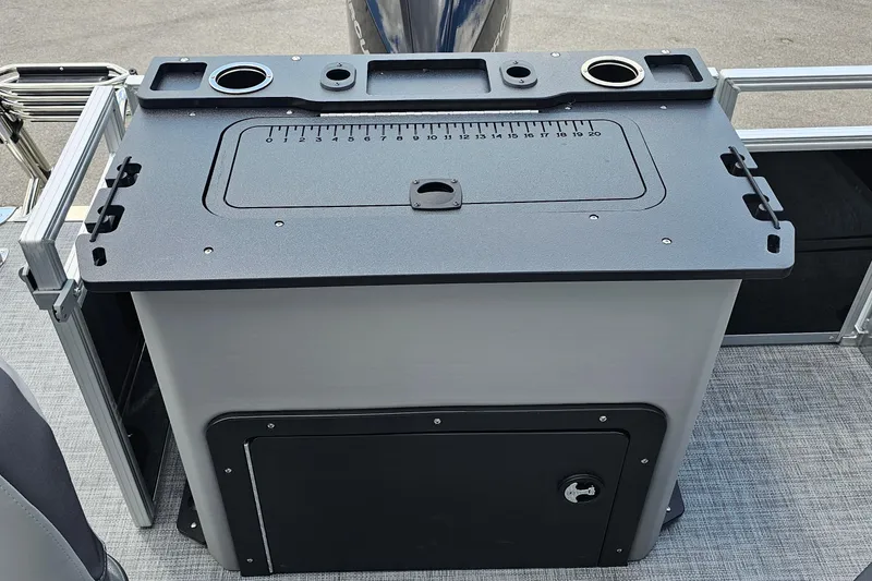 Slide: The Image of 2026 Sun Tracker Sportfish 24 XP3 fishing station with integrated measuring board and cup holders. - 20