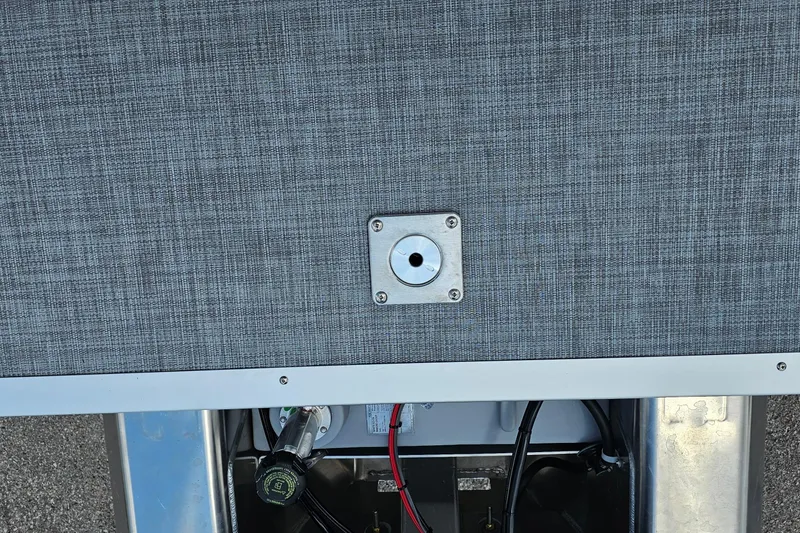 Slide: The Image of 2026 Sun Tracker Sportfish 24 XP3 boat deck with metal fitting and visible wiring. - 23