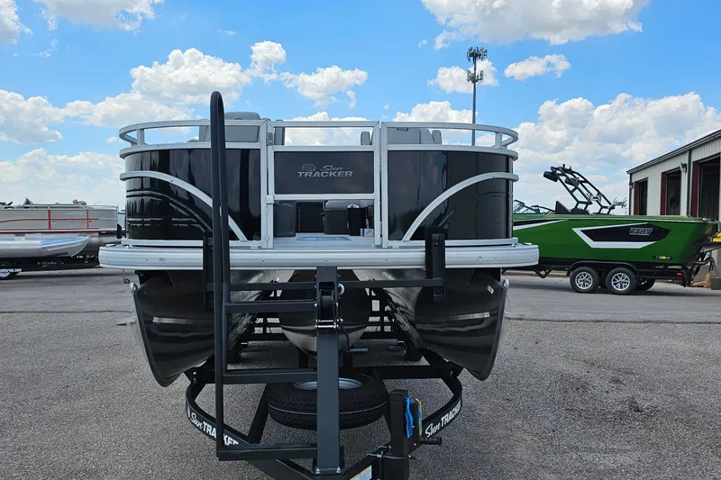 Slide: The Image of 2026 Sun Tracker Sportfish 24 XP3 pontoon boat on trailer, parked outdoors. - 4