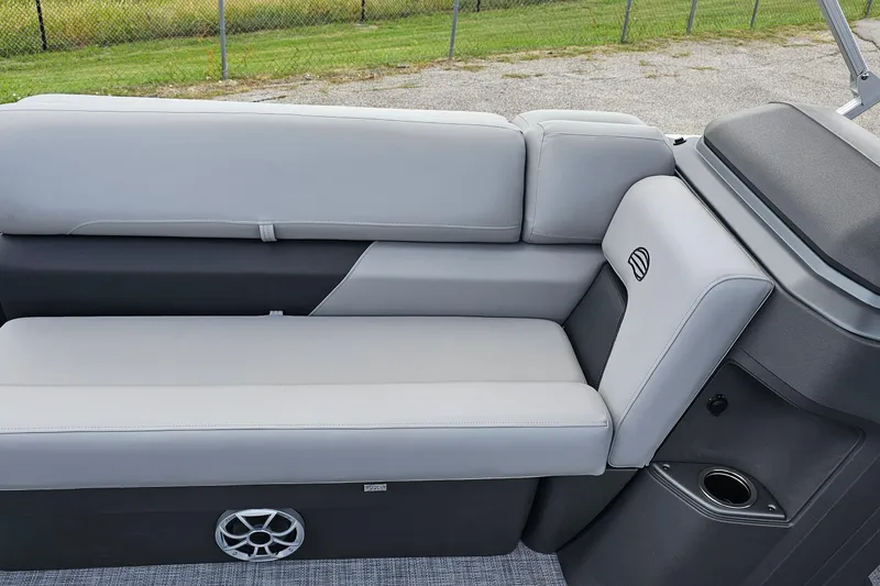 Slide: The Image of 2026 Sun Tracker Sportfish 24 XP3 boat interior with gray seating and speaker. - 9