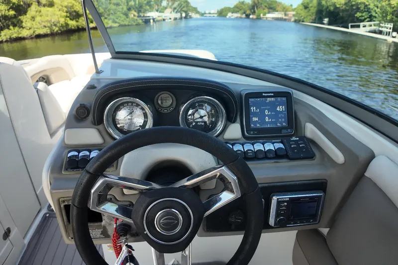 Slide: The Image of Steering console of a 2020 Crownline 24 boat on a scenic waterway. - 13