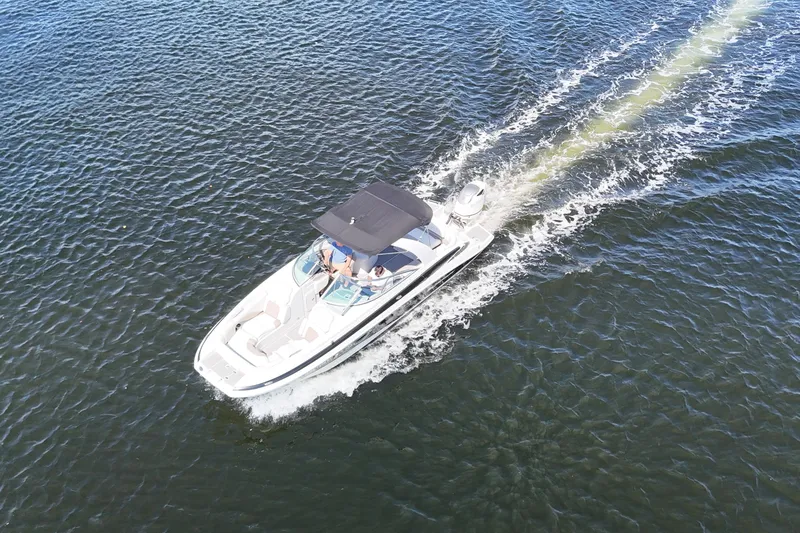 Slide: The Image of Aerial view of 2020 Crownline 24 boat cruising on open water. - 20