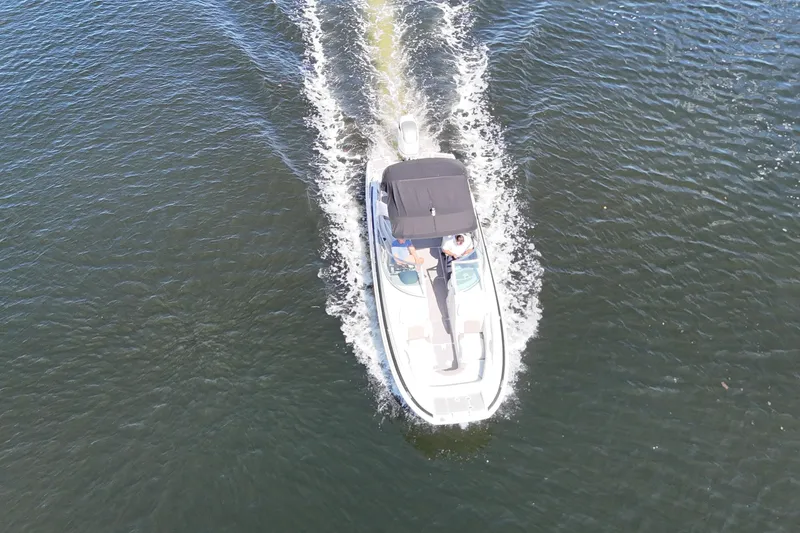 Slide: The Image of Aerial view of 2020 Crownline 24 boat cruising on open water. - 21