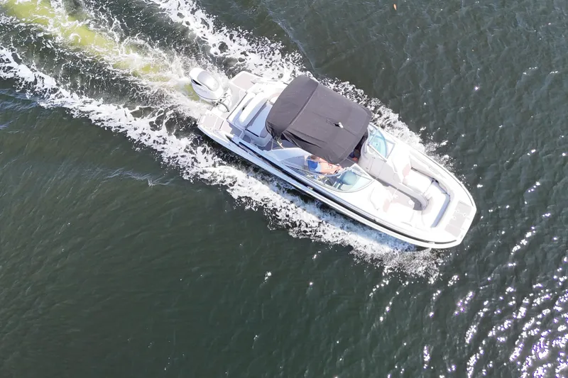 Slide: The Image of Aerial view of 2020 Crownline 24 boat cruising on open water. - 22