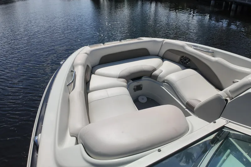Slide: The Image of 2020 Crownline 24 boat with spacious seating on calm water. - 27