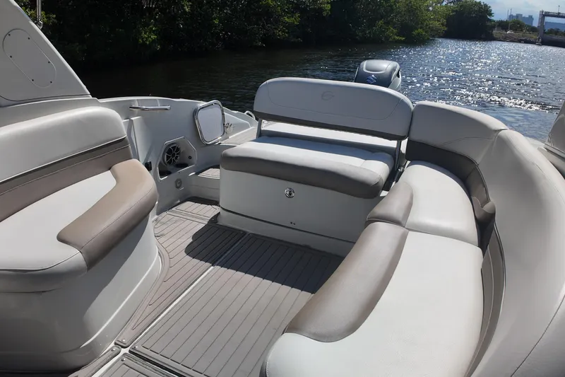 Slide: The Image of 2020 Crownline 24 boat interior with spacious seating, on a sunny day by the water. - 29