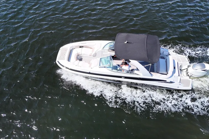 Slide: The Image of Aerial view of 2020 Crownline 24 boat cruising on open water. - 4