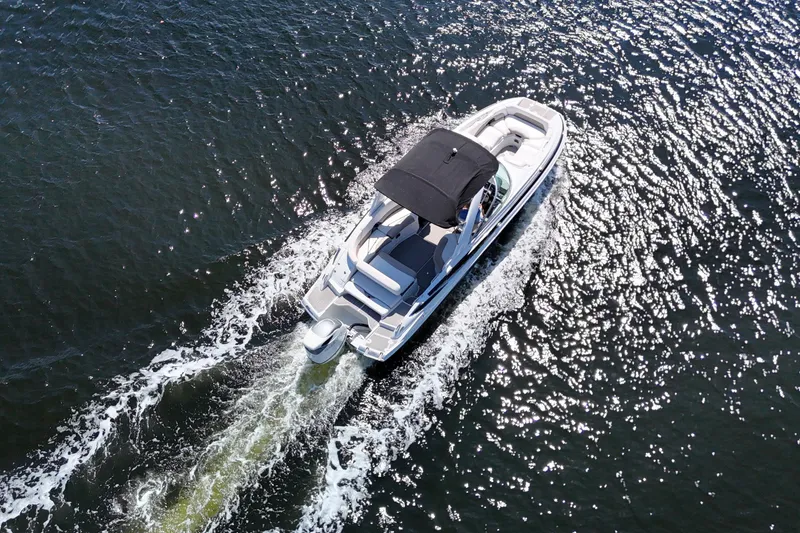 Slide: The Image of Aerial view of 2020 Crownline 24 boat cruising on sparkling water. - 6