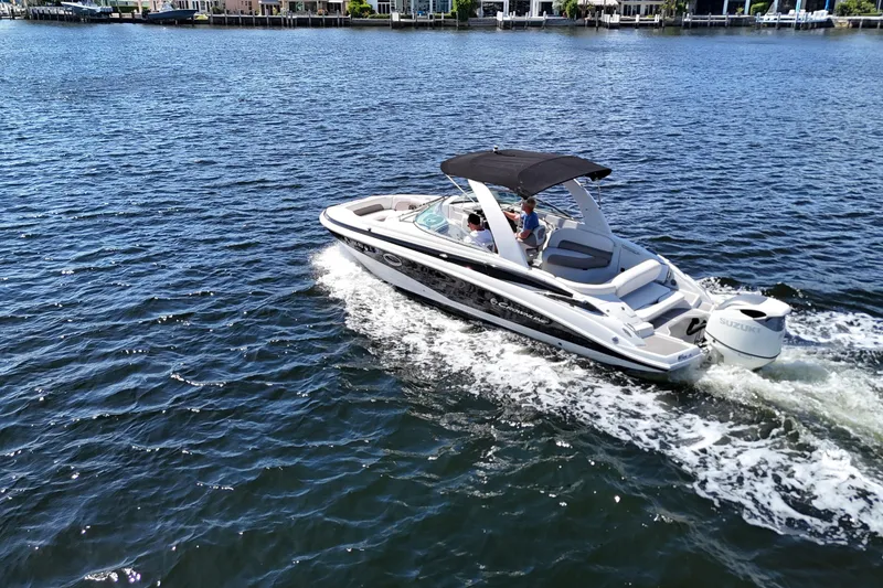 Slide: The Image of 2020 Crownline 24 boat cruising on a sunny day in a scenic waterway. - 7