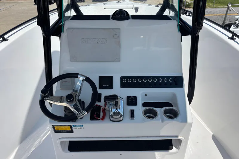 Slide: The Image of 2022 Cape Horn 22 OS boat console with steering wheel and control panel. - 20