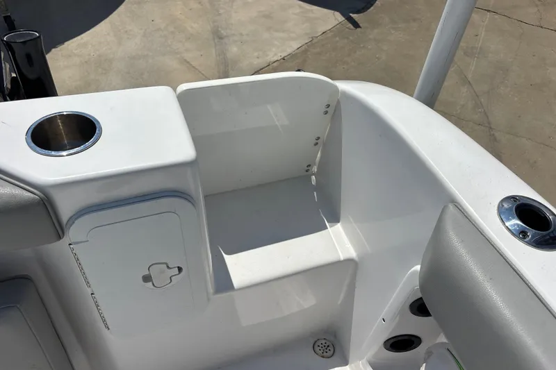 Slide: The Image of 2022 Cape Horn 22 OS boat interior with cup holders and storage compartment. - 41