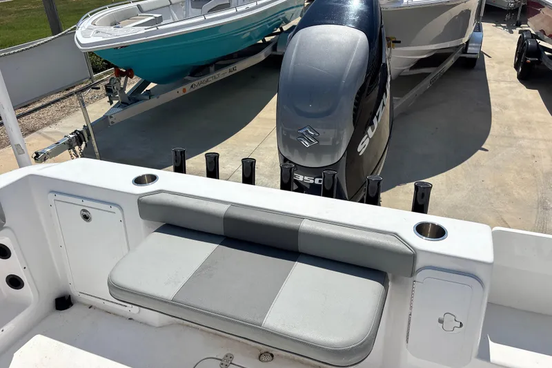 Slide: The Image of 2022 Cape Horn 22 OS boat with Suzuki 350 engine, featuring a cushioned seat and rod holders. - 44