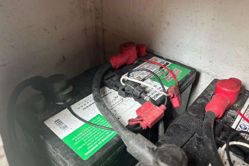 Slide: The Image of Batteries with red and black cables in a 2022 Cape Horn 22 OS boat. - 71