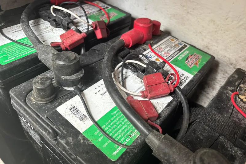Slide: The Image of Batteries with red and black cables in a 2022 Cape Horn 22 OS boat. - 72