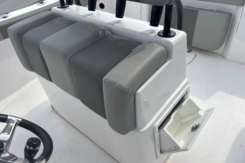 Slide: The Image of Cape Horn 22 OS 2022 boat interior with cushioned seating and open storage compartment. - 79