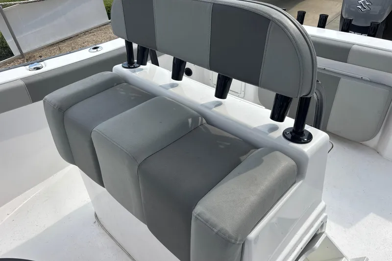 Slide: The Image of 2022 Cape Horn 22 OS boat seating with rod holders, featuring gray upholstery. - 80