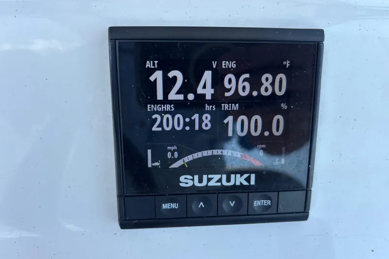 Slide: The Image of Digital display on a 2022 Cape Horn 22 OS showing engine metrics and Suzuki branding. - 47